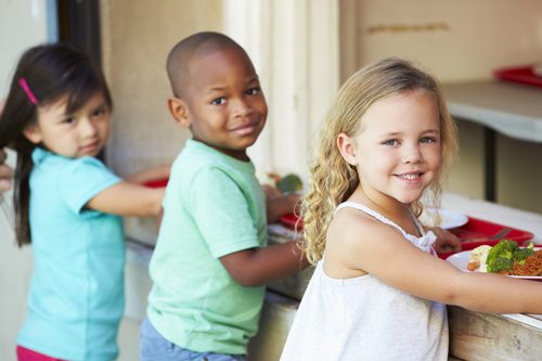 Elementary Pupils Collecting Healthy Lunch In Cafeteria